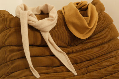 Finding Dodo Kaschmir-Dreiecktücher in Mustard und Pearl dekorativ drapiert auf einer braunen modischen Couch.